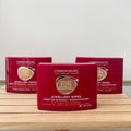 Three boxes of Connoisseurs Gold & Silver Jewellery Wipes on a wooden surface with a white background.